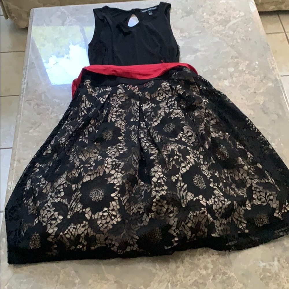 Karin Stevens black lace dress with red ribbon